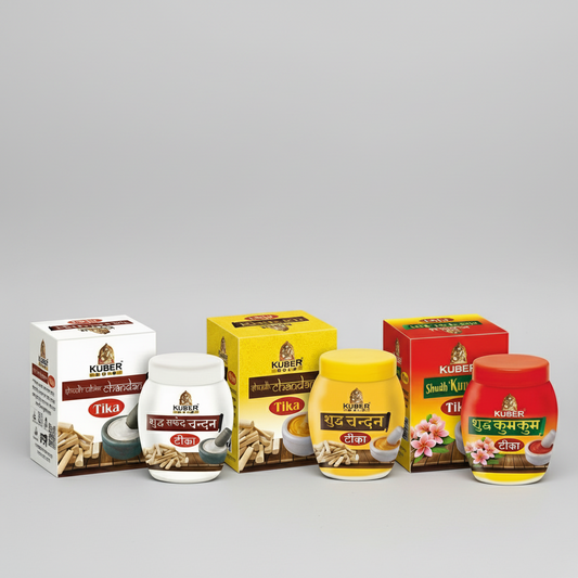 Collection of Kuber Nivas products including jars and boxes on a wooden surface with draped fabric in the background.